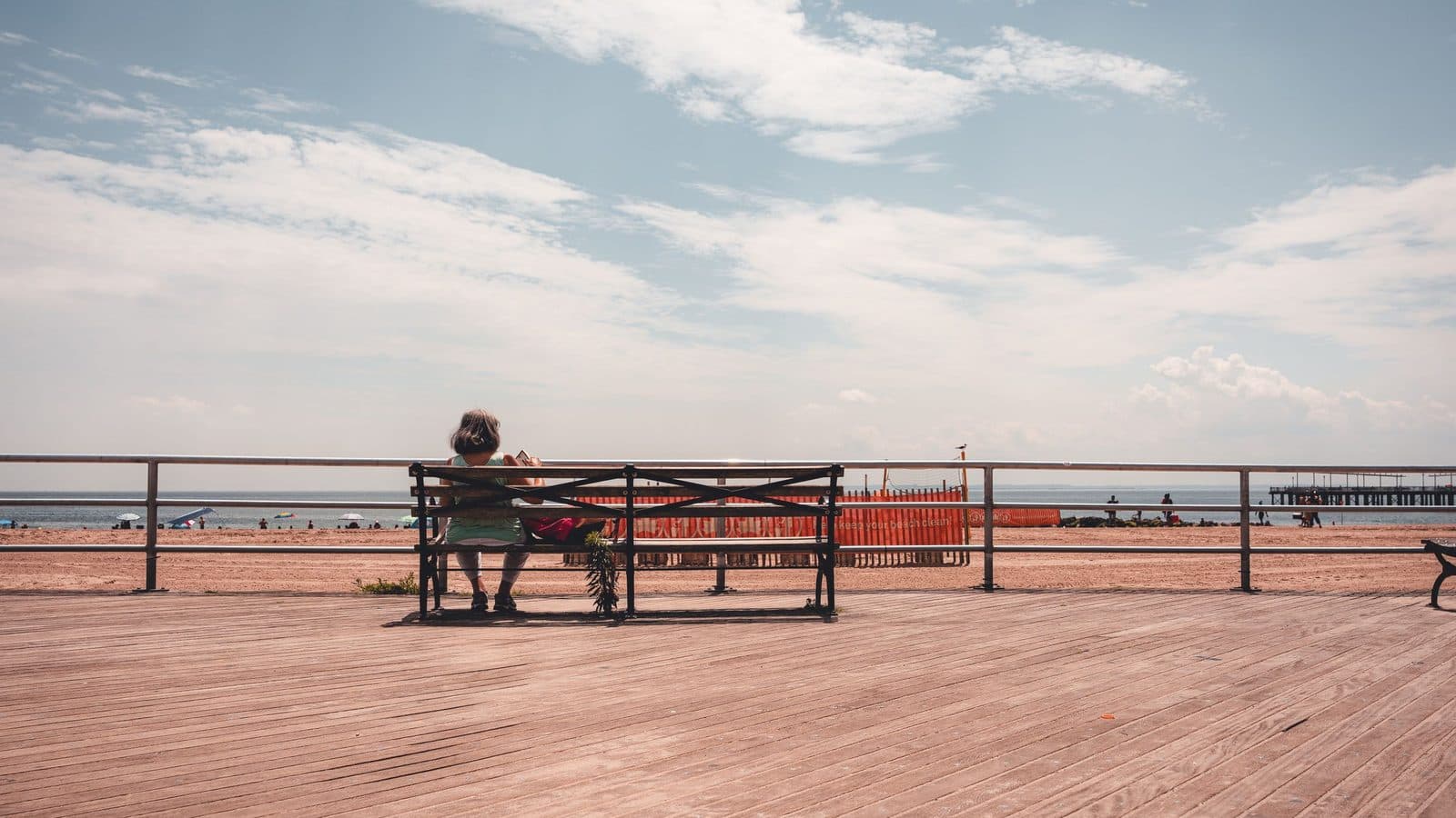 A wooden bench on a Delaware beachfront boardwalk