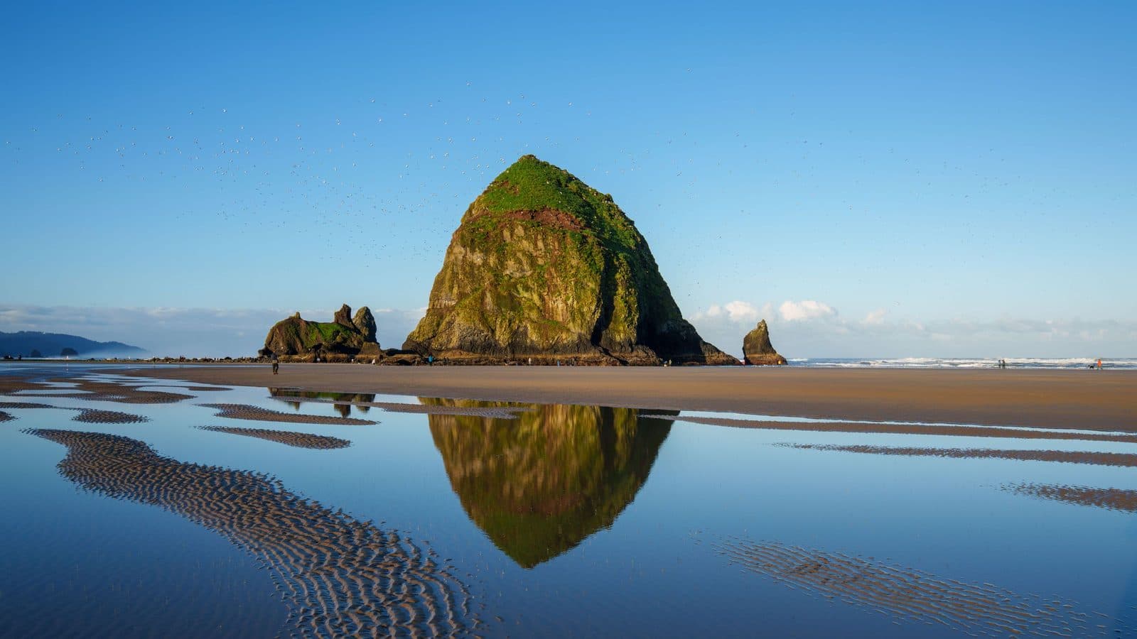 Haystack Rock reflected in tidal pools on the Oregon coast