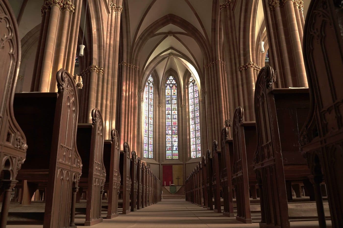 Light through the windows of an empty church sanctuary