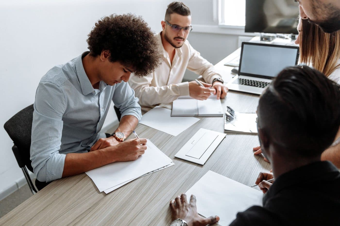 A small group working through material together around a table