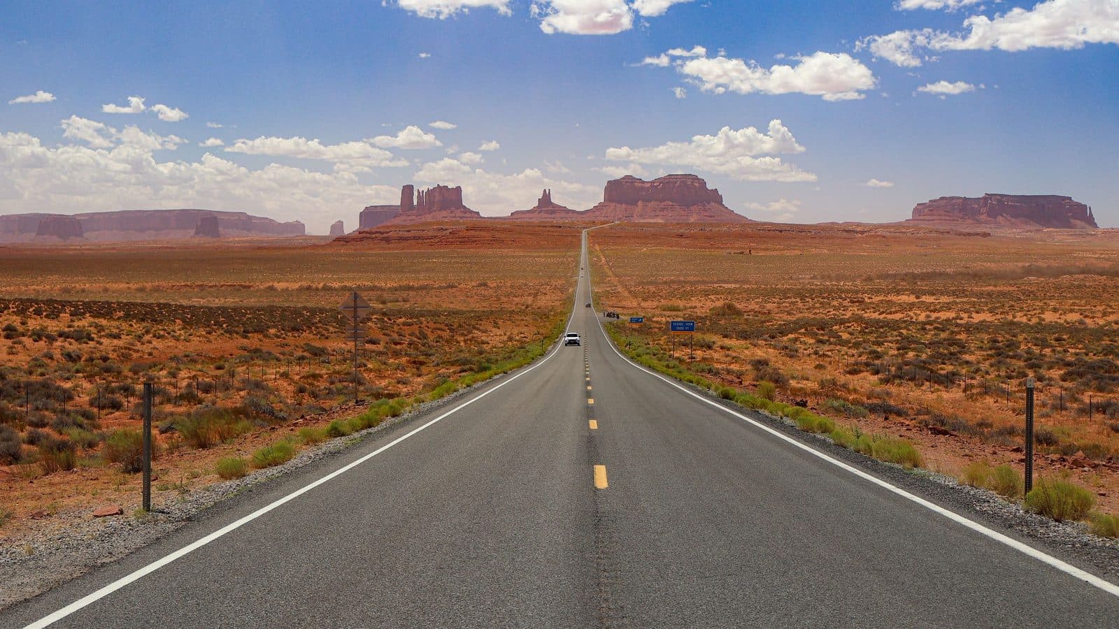 An empty highway running through open country