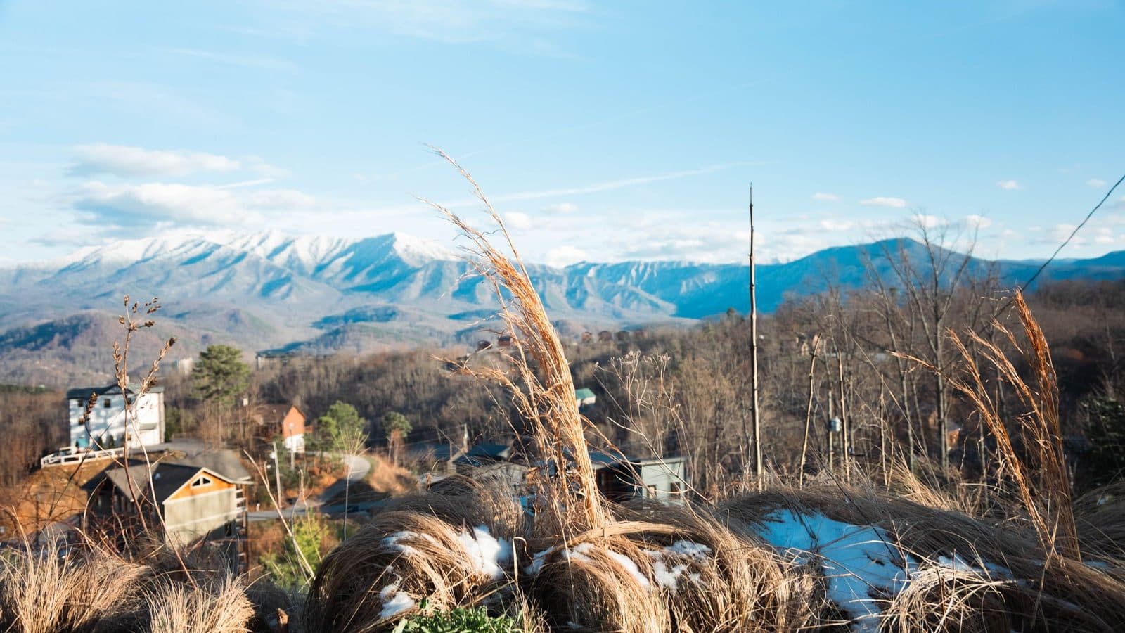 Snow-dusted Tennessee mountains layered above open countryside
